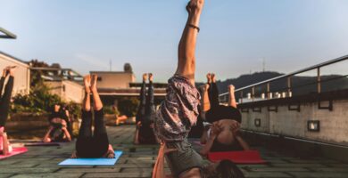 Group of Women Lying on Yoga Mat Under Blue Sky