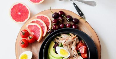 Bowl of Vegetable Salad and Sliced Fruits